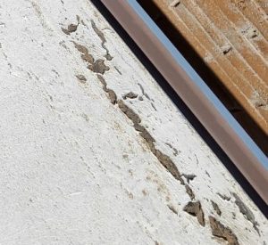 Cracks along roof drip edge before elastomeric roof coating